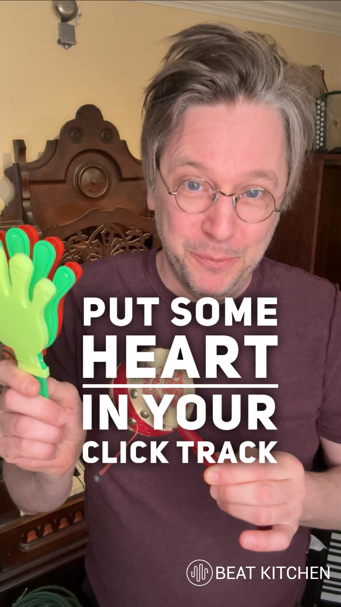 Nathan holding a hand clapper with text: Put Some Heart In Your Click Track