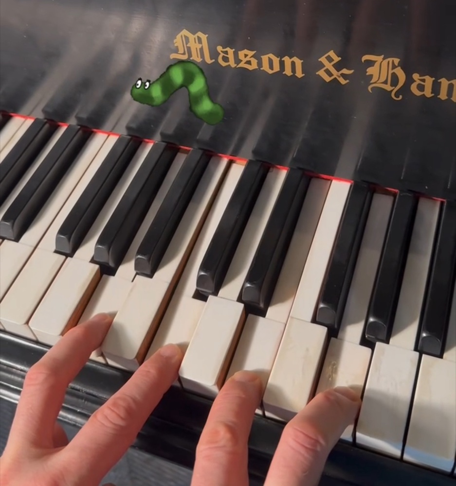 Cartoon caterpillar on piano keys — the voice leading exercise